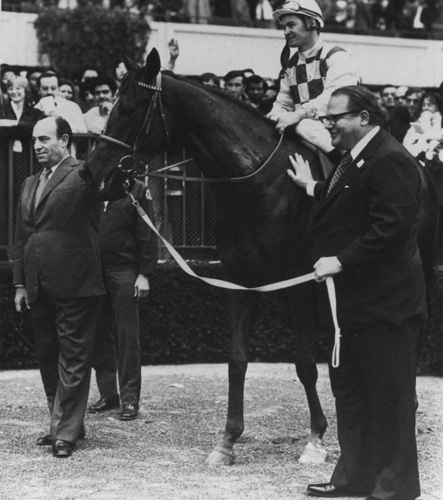 Dahlia (Ron Turcotte up) with trainer Maurice Zilber and owner Nelson Bunker Hunt entering the winner's circle for the 1974 Man o' War Stakes (NYRA/Museum Collection)