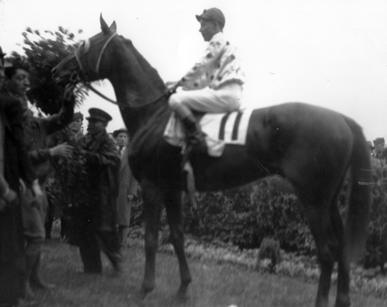 Omaha (Willie Saunders up) in the winner's circle for the 1935 Kentucky Derby (Churchill Downs Inc./Kinetic Corp. /Museum Collection)