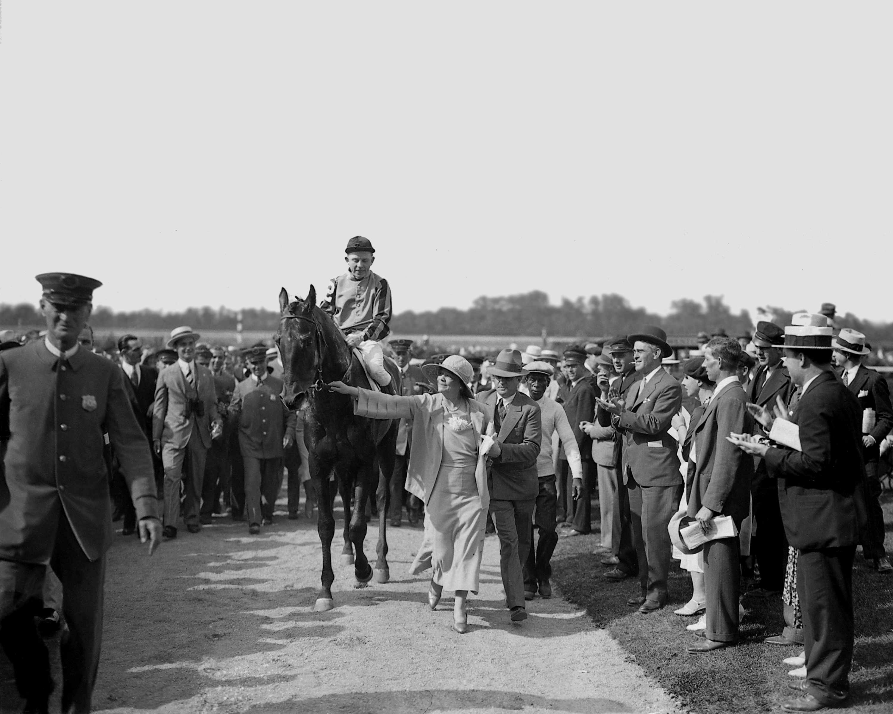 Twenty Grand (Charles Kurtsinger up) being led in by his owner, Helen Hay Whitney (Keeneland Library Cook Collection)