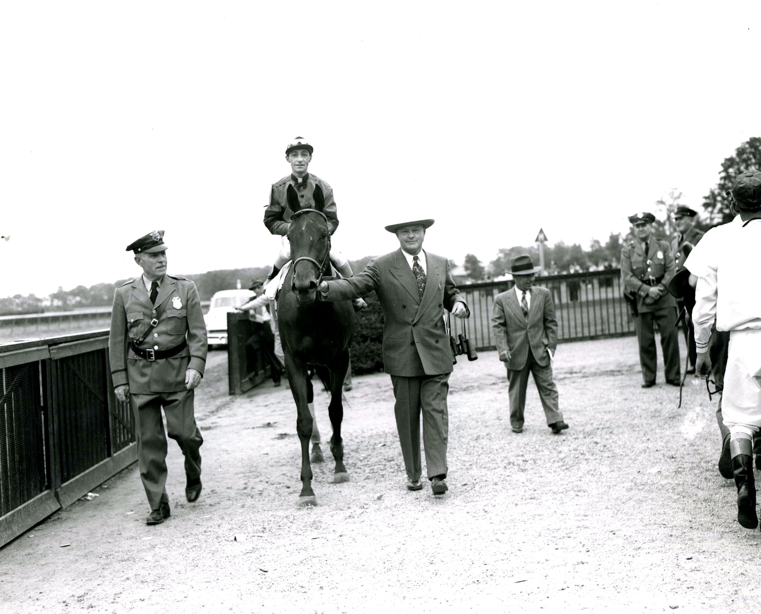 Real Delight (Eddie Arcaro up) entering the Belmont Park winner's circle at the 1952 Coaching Club American Oaks with trainer Ben Jones (Keeneland Library Morgan Collection/Museum Collection)