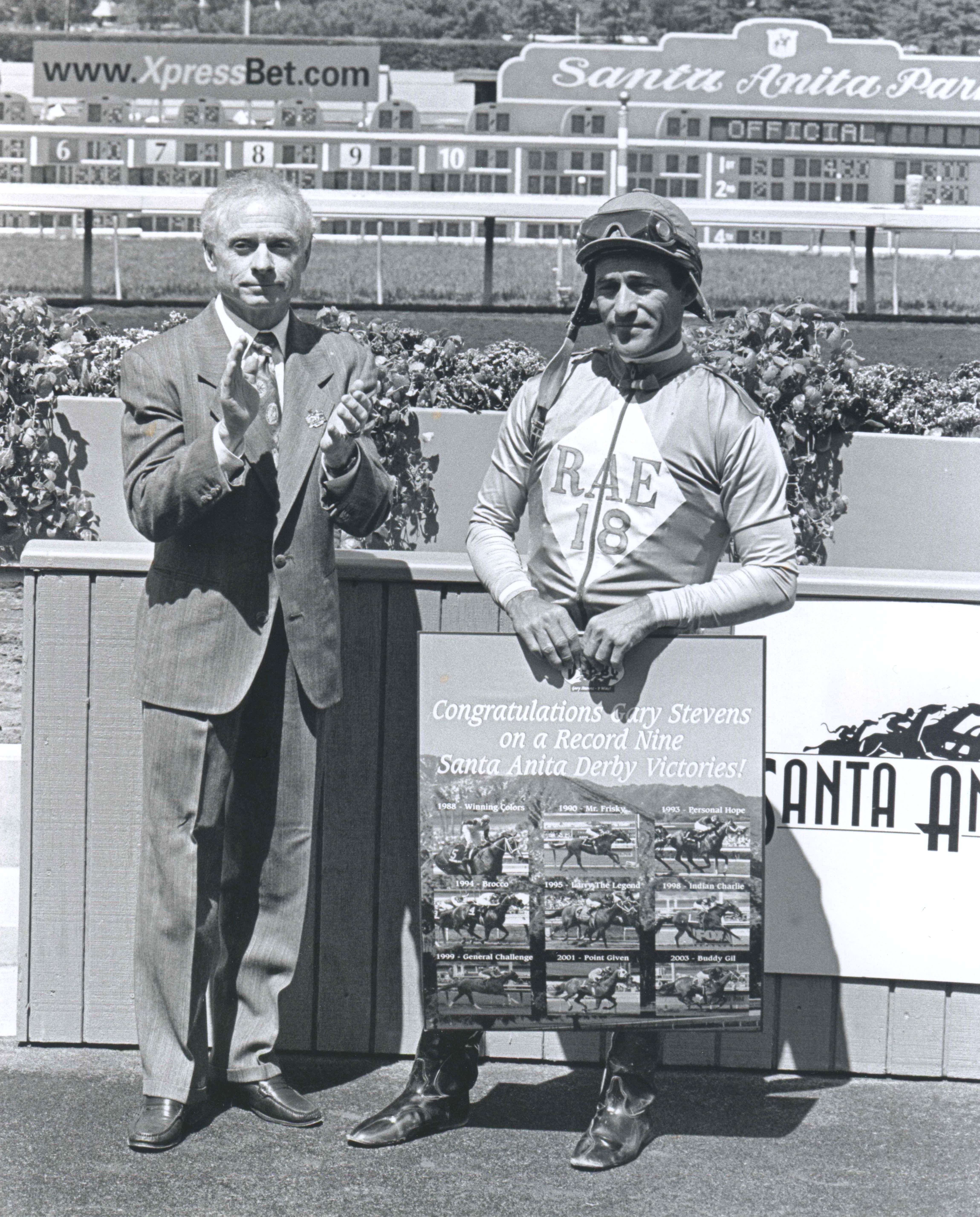 Santa Anita General Manager and Hall of Fame jockey Chris McCarron celebrates Gary Stevens record nine Santa Anita Derby victories, April 19, 2003 (Gary Stevens is seen holding a plaque  (Bill Mochon/Museum Collection)