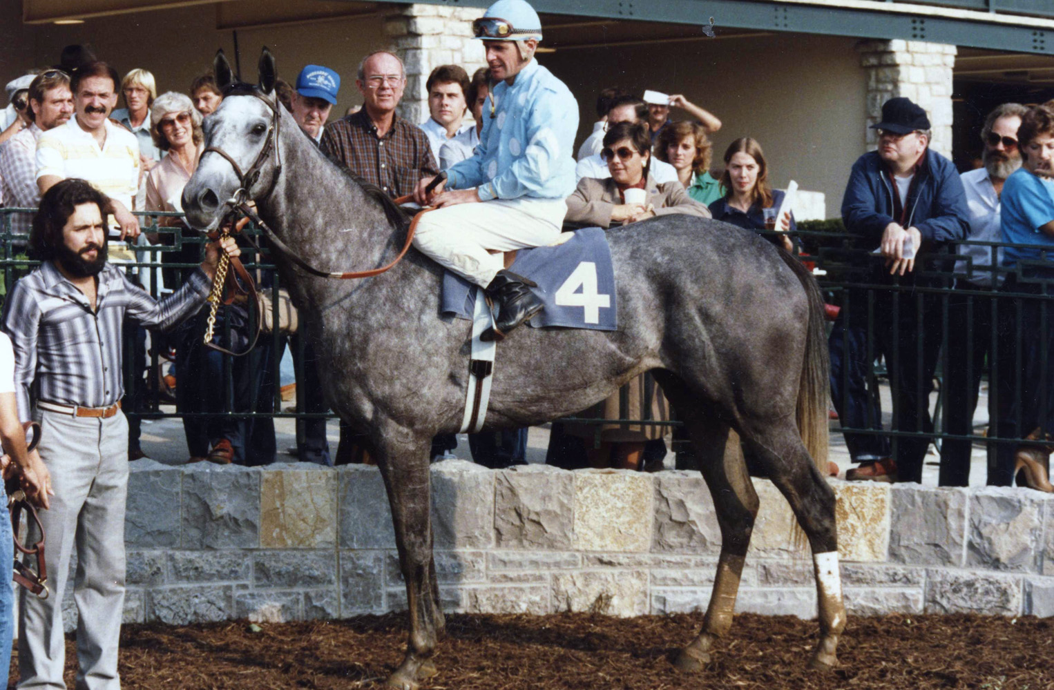 Eddie Delahoussaye and Princess Rooney in the winner' circle at Keeneland in 1984 (Barbara D. Livingston/Museum Collection)