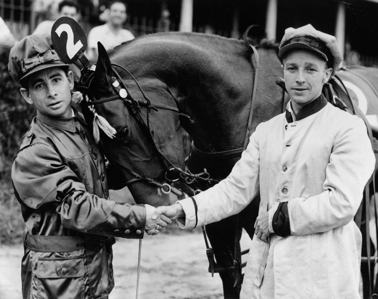 Johnny Longden and Wayne Wright shaking hands at an exhibition trotting race at Empire City in August 1943 (Acme Photo/Courtesy of Ken Grayson)