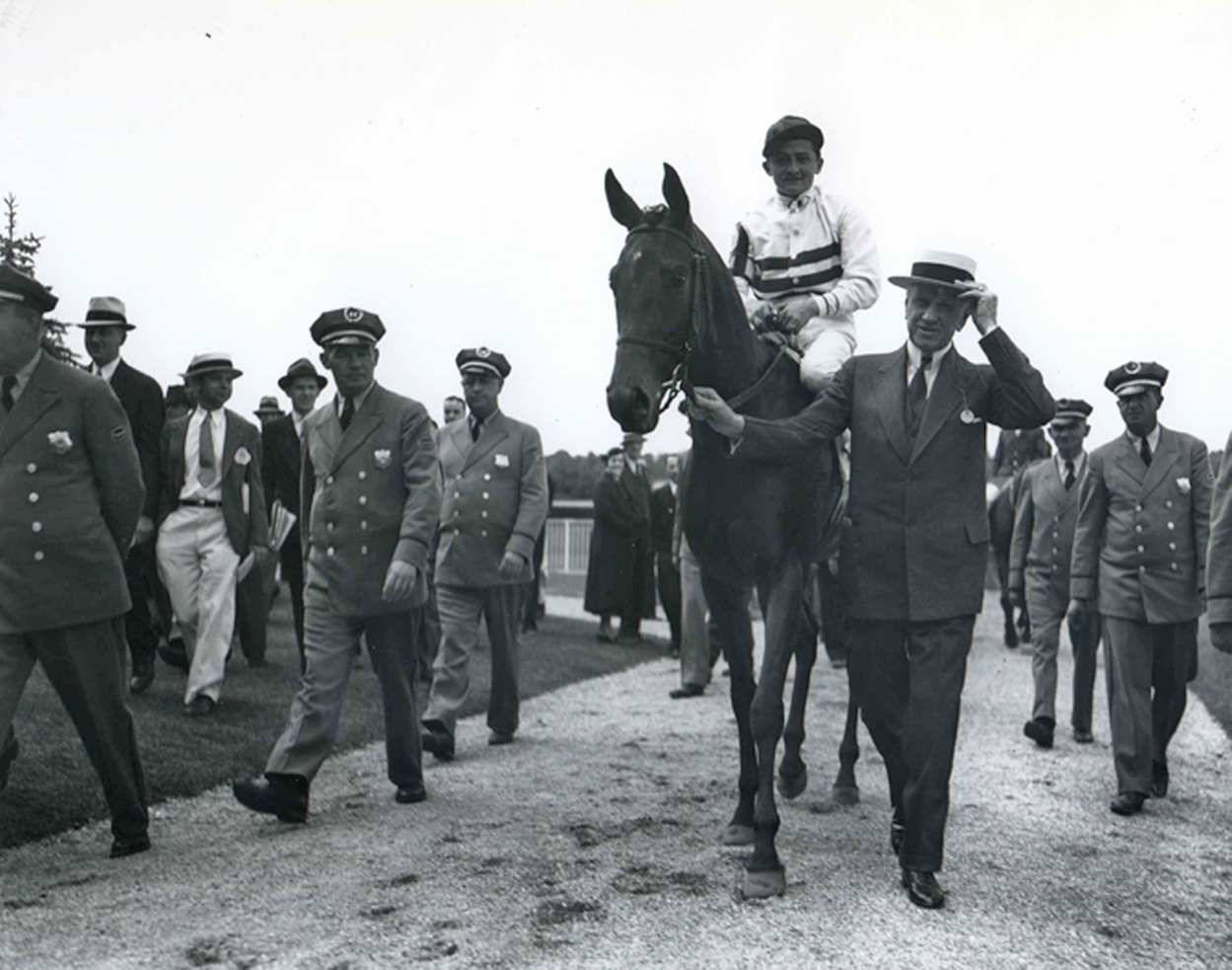 E. R. Bradley leads in Black Helen (Don Meade up) after winning the 1935 Coaching Club American Oaks (Keeneland Library Morgan Collection/Museum Collection)