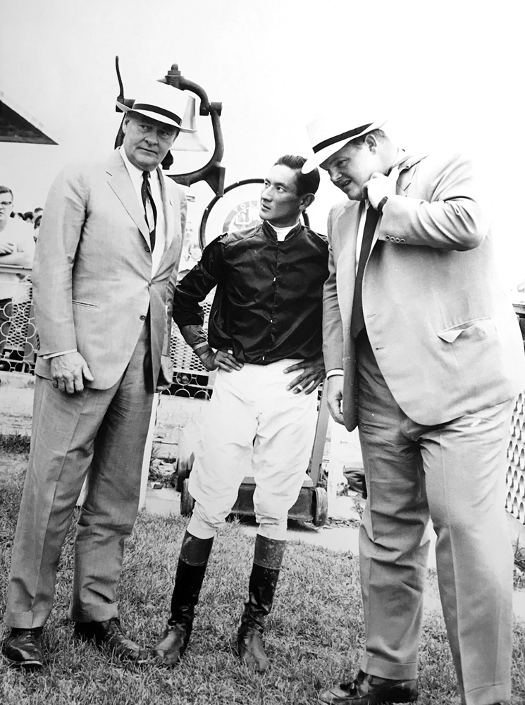 Dinny Phipps (right) with his father Ogden Phipps and jockey Braulio Baeza in 1960 (Keeneland Library Thoroughbred Times Collection)