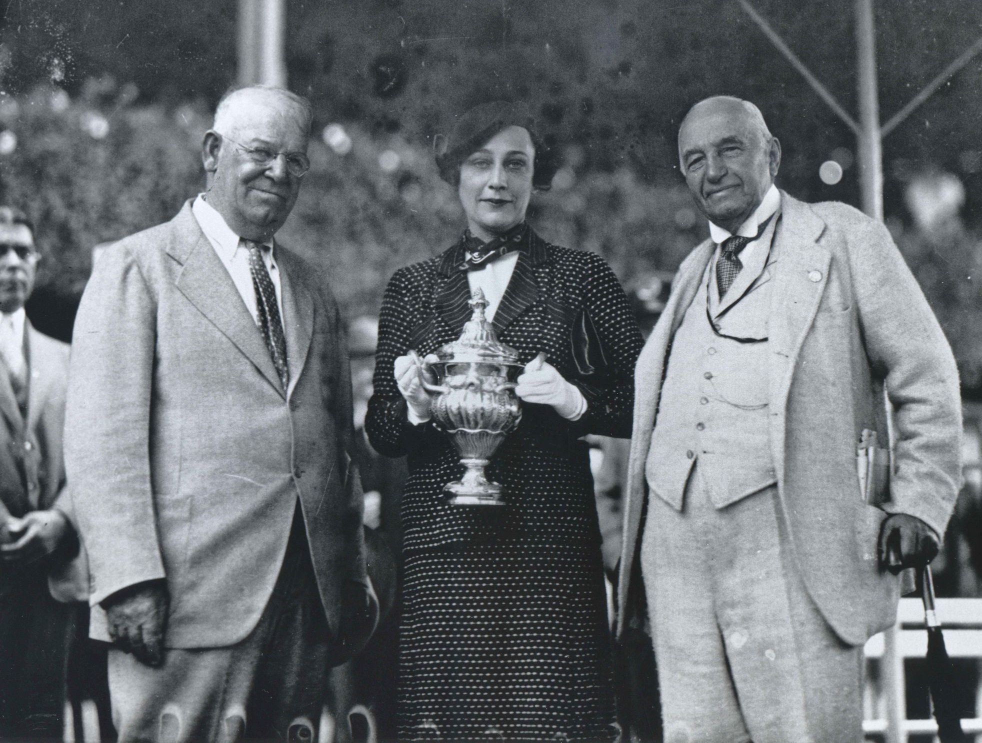 Trainer Robert Smith and owner Isabel Dodge Sloane receive the 1934 Sanford Stakes trophy for Psychic Bid from John Sanford at Saratoga (Keeneland Library Cook Collection/Museum Collection)