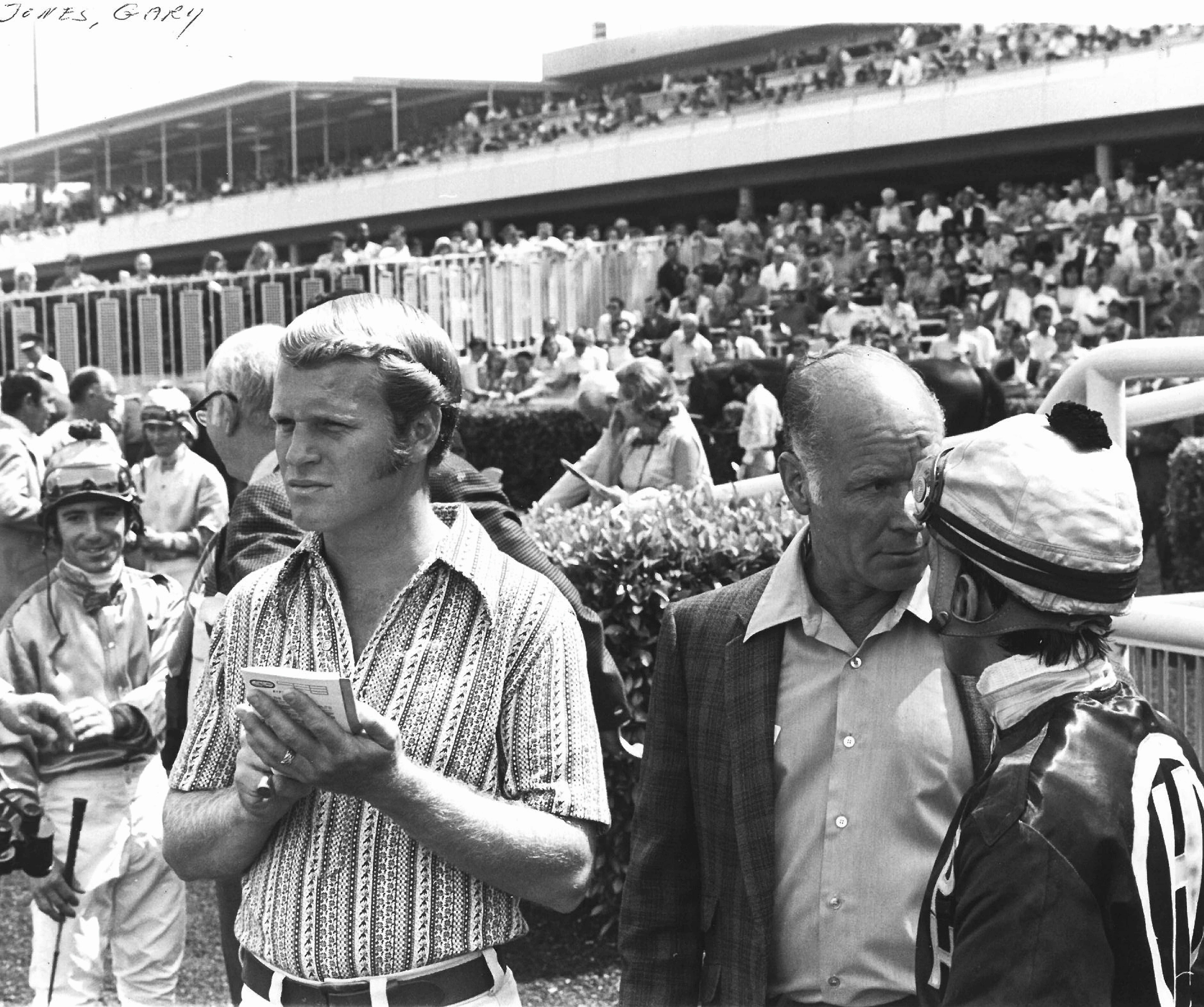 A young Gary Jones at the track with his father, Farrell Jones, amidst the jockey colony before a race (Benoit Photo)