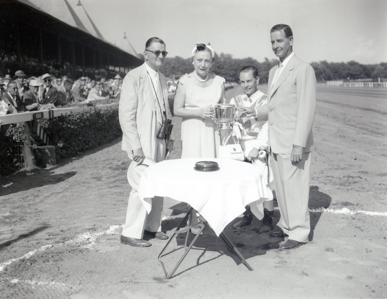 Preston M. Burch, Isabel Dodge Sloane, Hedley J. Woodhouse, and C. V. Whitney at the 1955 Whitney trophy presentation at Saratoga (Keeneland Library Morgan Collection/Museum Collection)