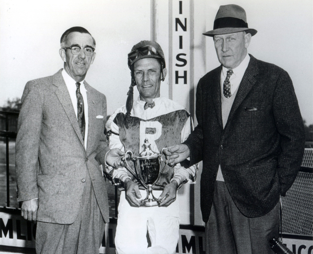 Owner L. H. Hunt, jockey Bobby Baird, and trainer Henry Clark accepting a trophy at Pimlico in 1963 (BloodHorse/Museum Collection)