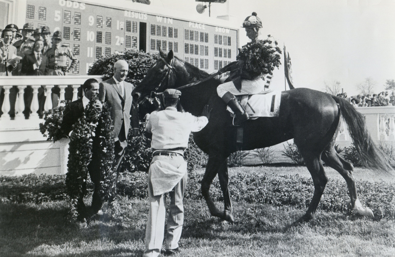 James Conway greets Chateaugay (Braulio Baeza up) in the winner's circle after their 1963 Kentucky Derby win (Museum Collection)