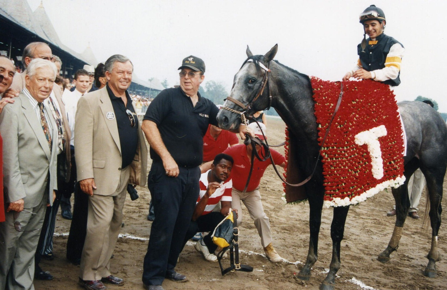 Jimmy Croll joins Holy Bull (Mike Smith up) in the winner's circle for the 1994 Travers Stakes (Barbara D. Livingston/Museum Collection)