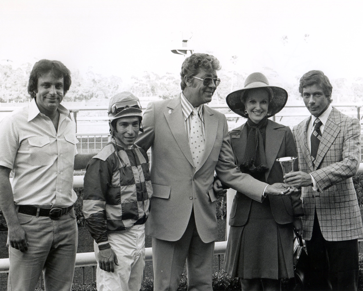 Bobby Frankel, jockey Laffit Pincay, Jr, actor Cliff Robertson, Linda Pincay, and an unidentified man. at a trophy presentation at Hollywood Park, May 1973 (Bill Mochon/Museum Collection)