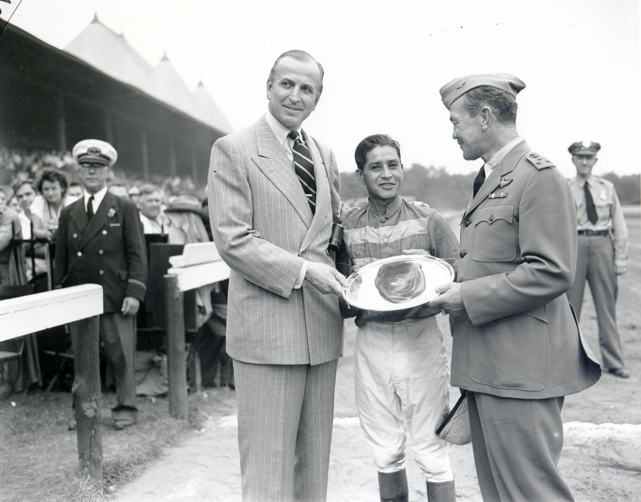 Trainer Horatio Luro, jockey Ruperto Donoso, and Vice Admiral Gerald F. Bogan at the trophy presentation from the 1947 Whitney (won by Rico Monte) at Saratoga (Keeneland Library Morgan Collection/Museum Collection)