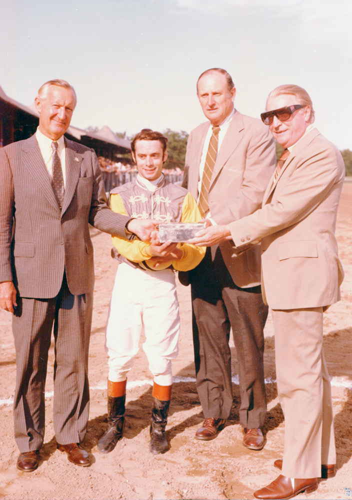 Paul Mellon, jockey Michael Venezia, and trainer Mack Miller receive the trophy for the 1977 Jim Dandy (won by Music of Time) at Saratoga Race Course (Bert and Richard Morgan/Museum Collection)