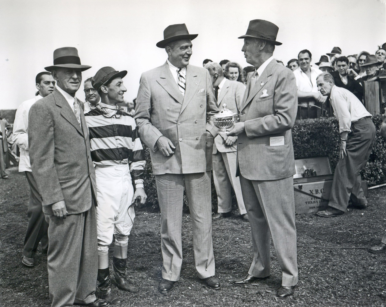 Trainer Bert Mulholland, jockey Eddie Arcaro, and owner George D. Widener, Jr. accept the trophy for the 1951 Withers Stakes at Belmont Park, won by Battlefield (Keeneland Library Morgan Collection/Museum Collection)