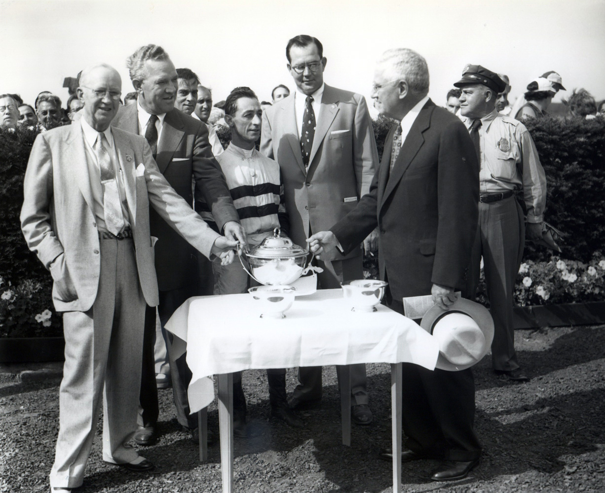 Jockey Eddie Arcaro and  trainer Eddie Neloy join others in a post-victory trophy presentation (Keeneland Library Morgan Collection/Museum Collection)