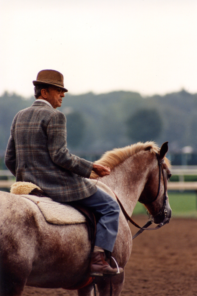 Woody Stephens on the track clocking a workout at Saratoga, August 1987 (Barbara D. Livingston/Museum Collection)