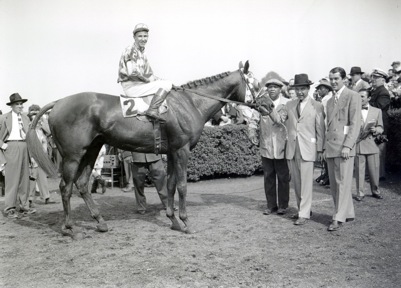 William C. Winfrey holds Loser Weeper (Nick Combest up) in the winner's circle for the 1950 Suburban Handicap at Belmont Park (Keeneland Library Morgan Collection/Museum Collection)